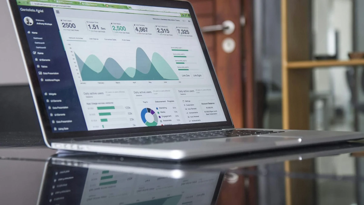 Laptop screen displaying dynamic startup financial model spreadsheet with runway and revenue forecasting charts